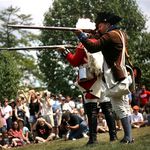 Re-enactors firing their weapons during a simulation of the Battle of Brooklyn.